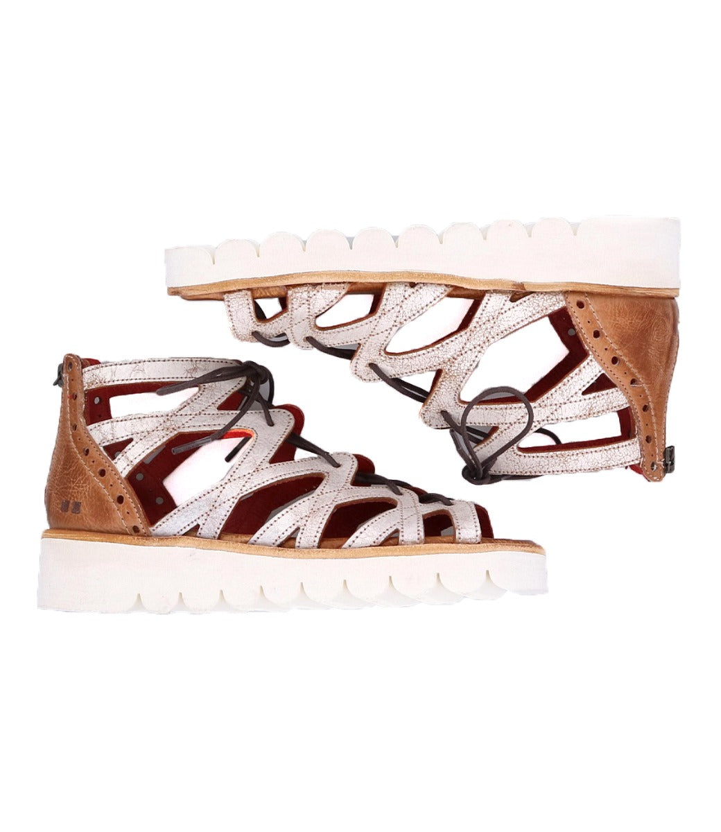 A pair of Bed Stu Shirin II women's sandals with white and brown straps.