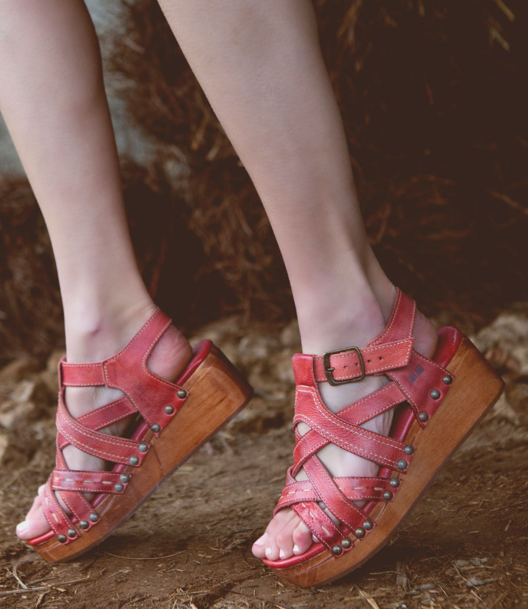 A woman's feet in a pair of Bed Stu Shirley sandals.