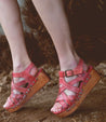 A woman's feet in a pair of Bed Stu Shirley sandals.