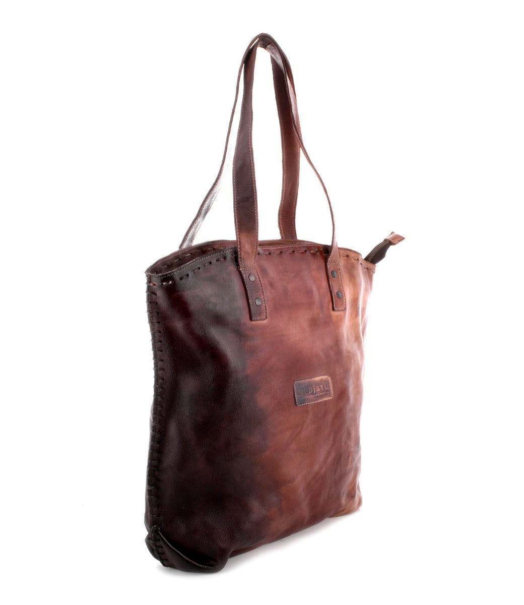 A Skye II brown leather tote bag on a white background by Bed Stu.