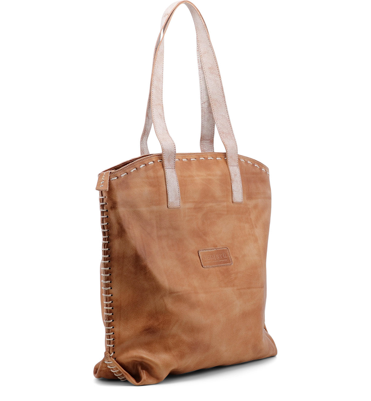 A Skye II tan leather tote bag with rivets by Bed Stu.