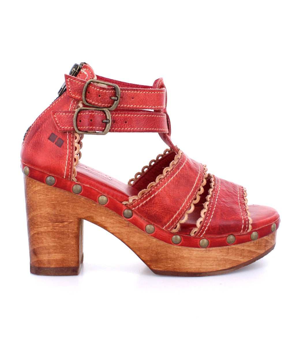 A women's red sandal with wooden platform and straps, called the Sloane by Bed Stu.