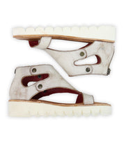 The Bed Stu Soni II are white platform sandals with cutout designs and side buttons, featuring thick, ridged XL EXTRALIGHT® outsoles for enhanced comfort and style, shown from a side view.