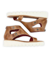 Brown leather Soni II sandals from Bed Stu, featuring thick white XL EXTRALIGHT® outsoles, a unique cutout design, metallic button accents, and a convenient back zipper, viewed from the side.