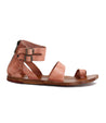 A pair of Bed Stu Afrodita women's pink sandals with buckles and straps.