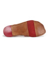 A pair of Bed Stu shoes with red and tan soles.