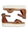 A pair of Carroll sandals by Bed Stu with red soles.
