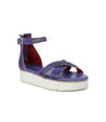 A woman's blue leather Carroll sandals with two straps and a white sole by Bed Stu.