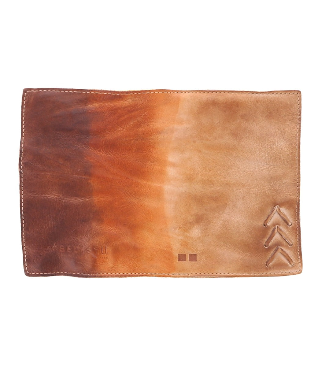 A brown leather Stardust passport sleeve with an arrow on it. (Brand: Bed Stu)
