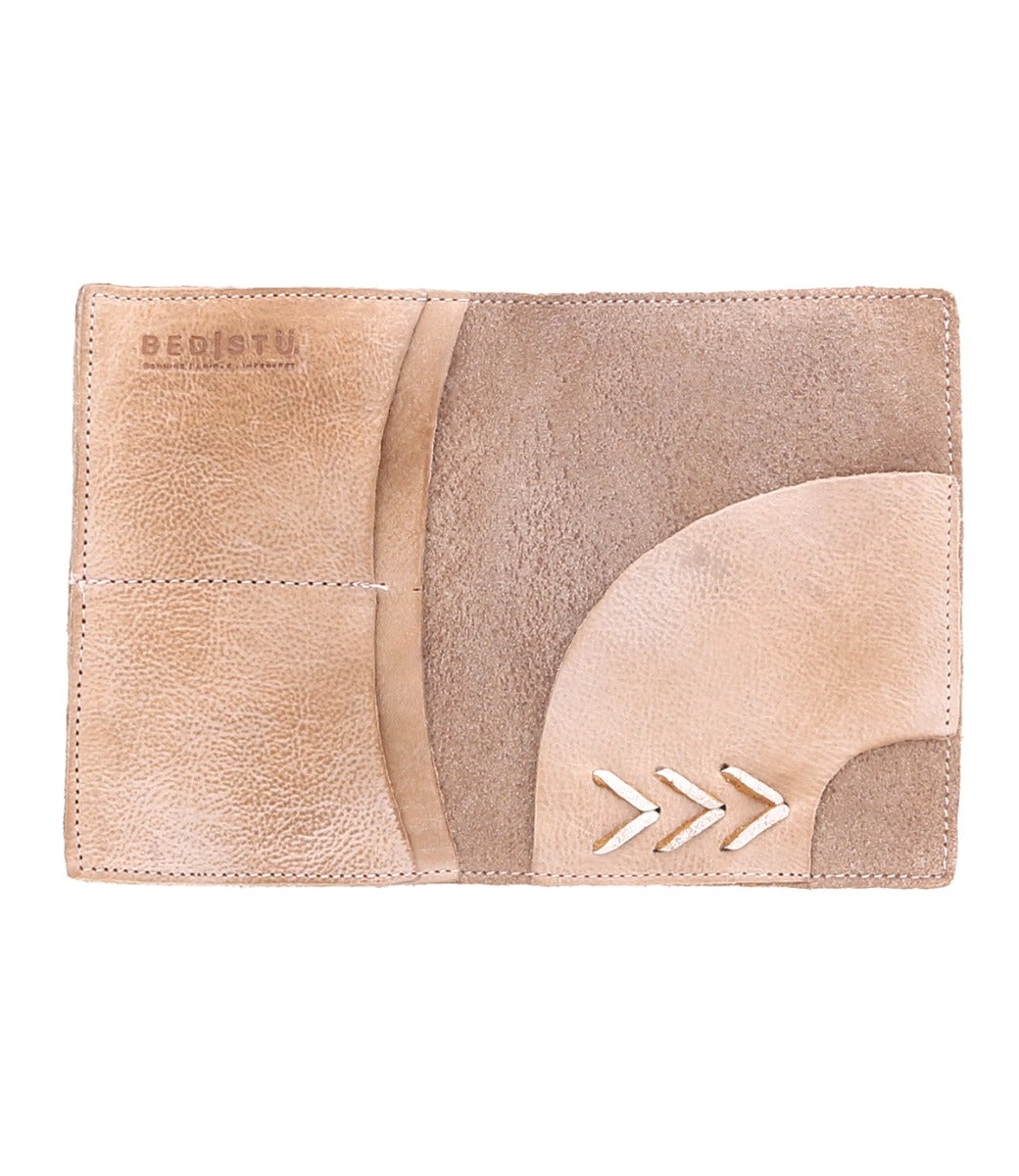 A brown leather Stardust passport holder with an arrow on it from Bed Stu.