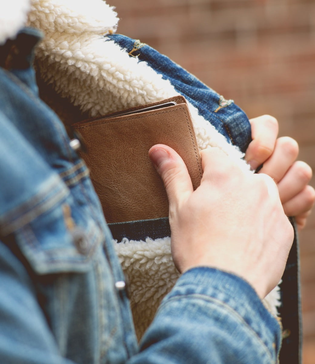 A man is holding a Stardust wallet in his jacket pocket.