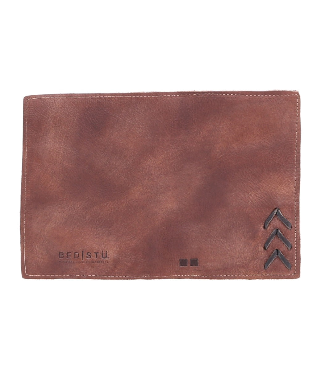 A brown leather Stardust wallet with an arrow on it, from the brand Bed Stu.
