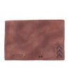 A brown leather Stardust wallet with an arrow on it, from the brand Bed Stu.