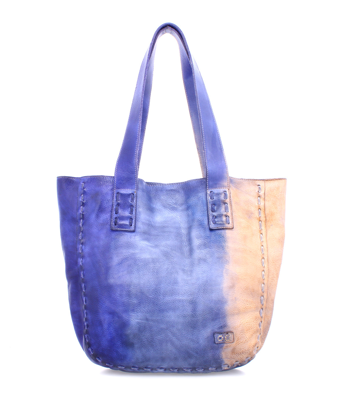 The Bed Stu Stevie tote bag showcases vintage-chic sophistication with its blue and tan leather, embodying the elegance of old-world craftsmanship.