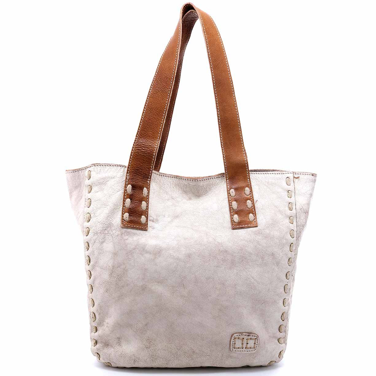 A white and brown Stevie tote bag with studded handles by Bed Stu.