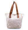 A white and brown Stevie tote bag with studded handles by Bed Stu.