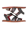 A pair of Sue black sandals with red soles by Bed Stu.
