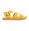 A pair of yellow Sue sandals with straps and buckles from the brand Bed Stu.