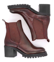 A pair of Bed Stu Surge Italian leather Chelsea boots with a higher heel on a white background.