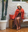 A woman sitting on a bench with a Bed Stu Tabitha cactus.