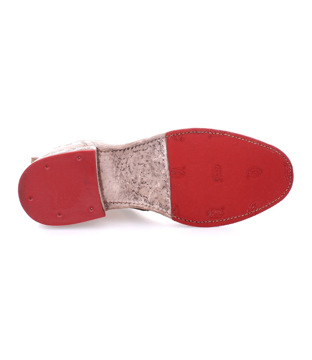 A pair of Bed Stu Tabitha shoes with red soles on a white background.