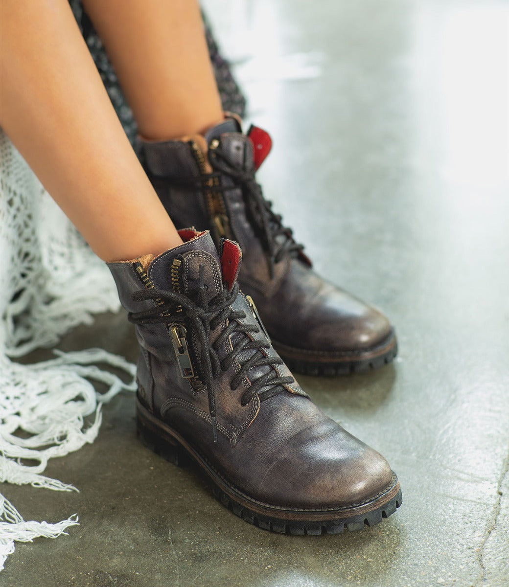 A woman's legs in a pair of Bed Stu Tactic Trek boots.