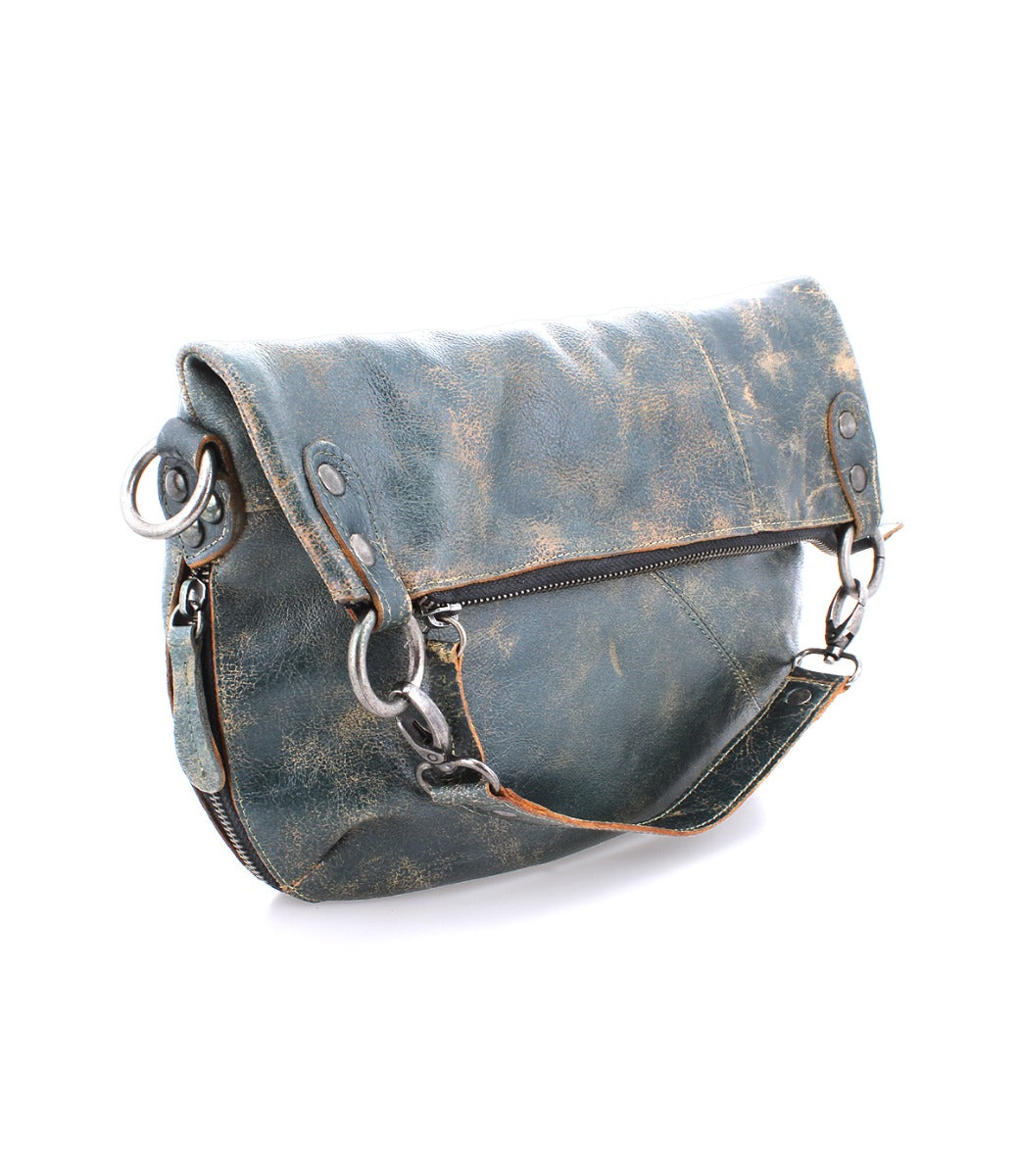 A blue leather Tahiti crossbody bag with metal straps by Bed Stu.