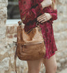 A woman in a red dress holding a Bed Stu Tahiti purse.