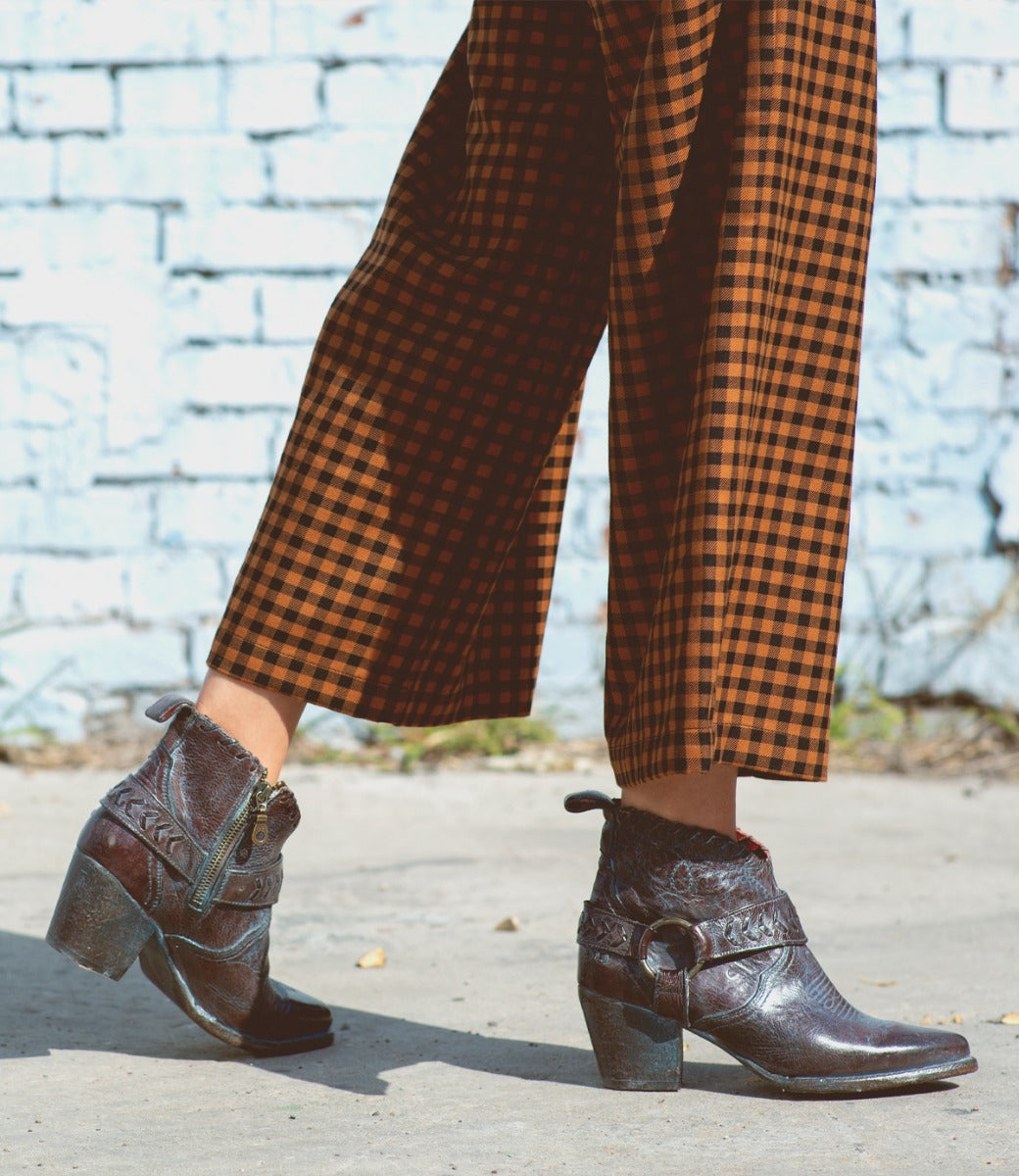 A woman wearing Tania pants and Bed Stu boots.