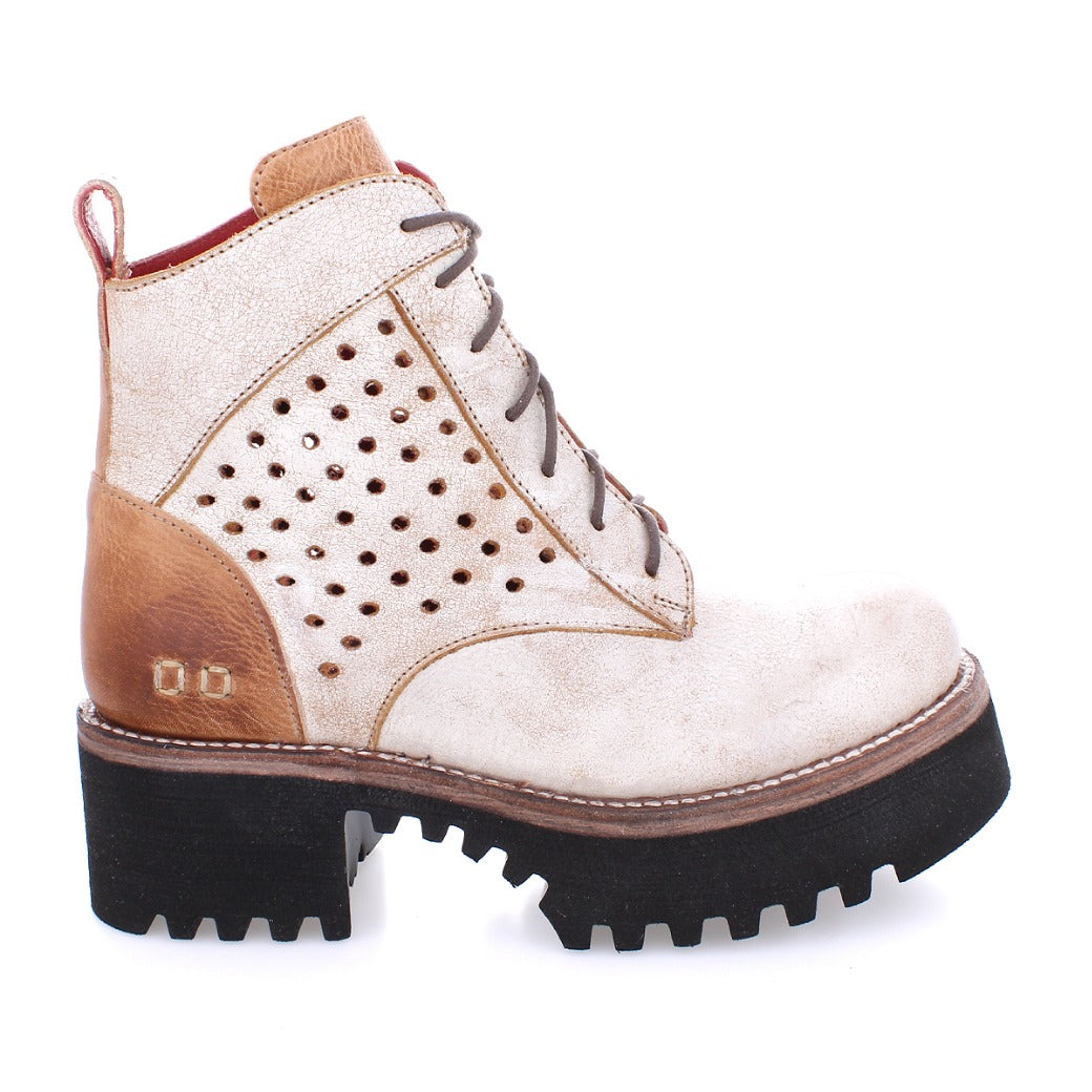 A women's Tanzania ankle boot with holes and a black sole by Bed Stu.