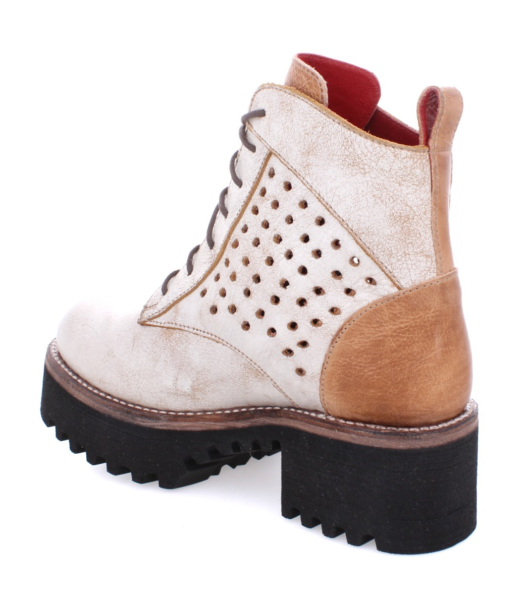 A women's ankle boot with perforations and a black sole called the Tanzania by Bed Stu.