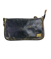 The Templeton II by Bed Stu is a distressed, black leather zippered pouch featuring frayed edges and a small, square yellow badge in the bottom right corner, ideal as a clutch for carrying essentials.