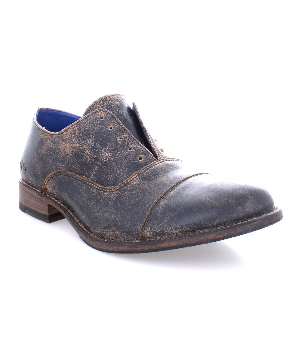 A men's brown oxford shoe with blue soles called the Thorn by Bed Stu.