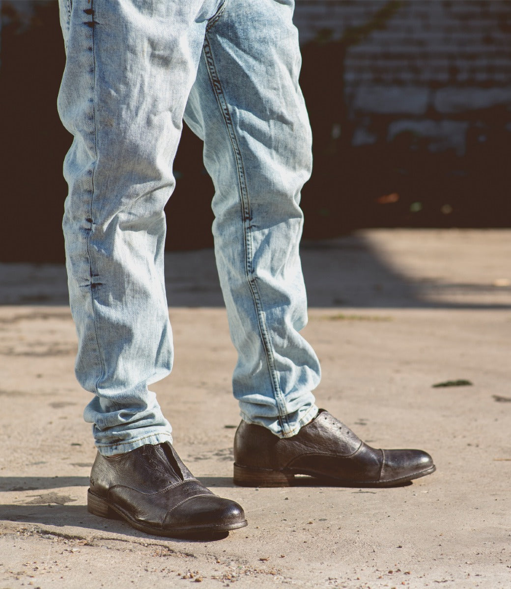 A man wearing jeans and a pair of Thorn shoes by Bed Stu.