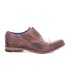 A pair of Thorn brown shoes with blue soles by Bed Stu.