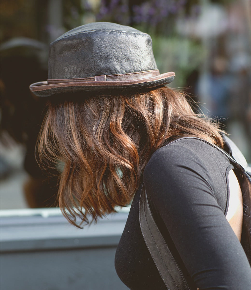 A woman wearing a Turino hat and Bed Stu backpack.