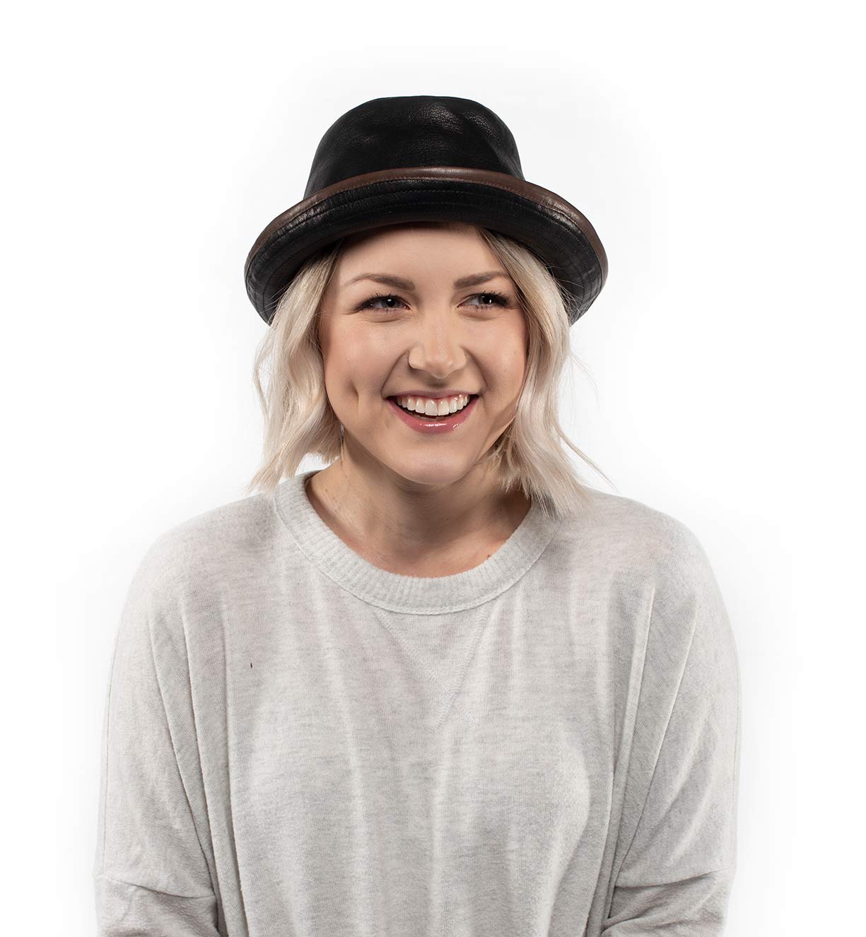 A woman wearing a Turino hat and Bed Stu white shirt.