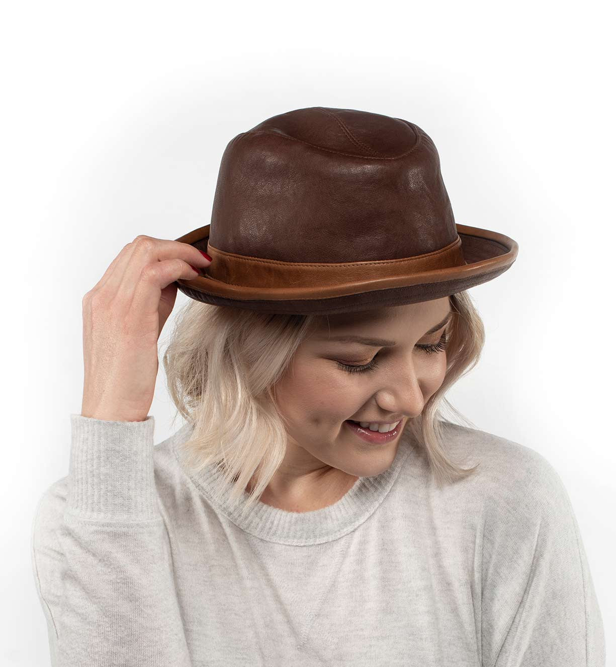 A woman wearing a brown Turino fedora hat by Bed Stu.