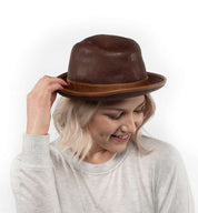 A woman wearing a brown Turino fedora hat by Bed Stu.