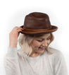 A woman wearing a brown Turino fedora hat by Bed Stu.