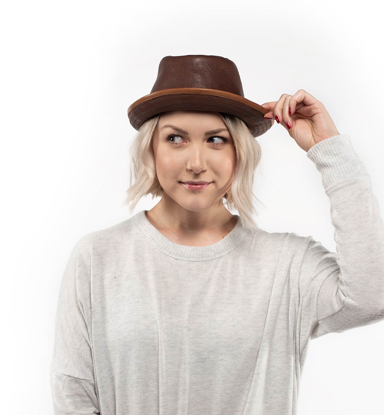 A woman wearing a brown Turino fedora hat by Bed Stu.