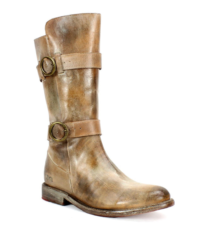 The Turn boot by Bed Stu is a brown leather footwear piece featuring two adjustable straps and brass buckles around the ankle and upper calf. Made from vegetable-tanned leather, it boasts a slightly worn appearance.