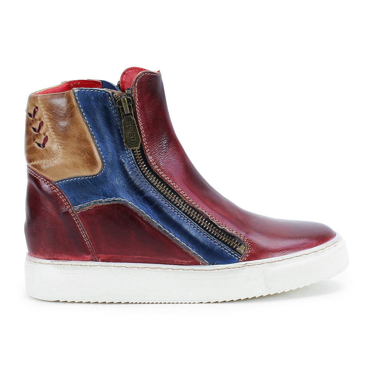 The Bed Stu Twist is a high-top sneaker featuring red, blue, and brown leather panels, a white sole, side zippers, and a hidden wedge for added height.