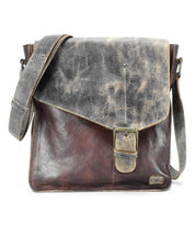 Introducing the Venice Beach by Bed Stu, a handcrafted leather crossbody bag with a distressed finish. This vintage-inspired piece showcases a buckle closure and adjustable strap, marrying timeless elegance with bohemian flair.