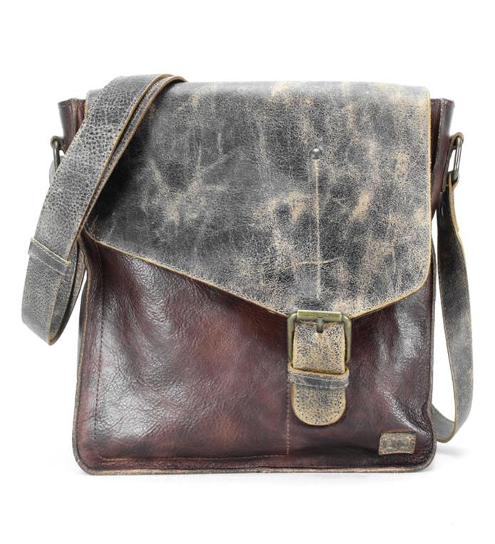 Introducing the Venice Beach by Bed Stu, a handcrafted leather crossbody bag with a distressed finish. This vintage-inspired piece showcases a buckle closure and adjustable strap, marrying timeless elegance with bohemian flair.