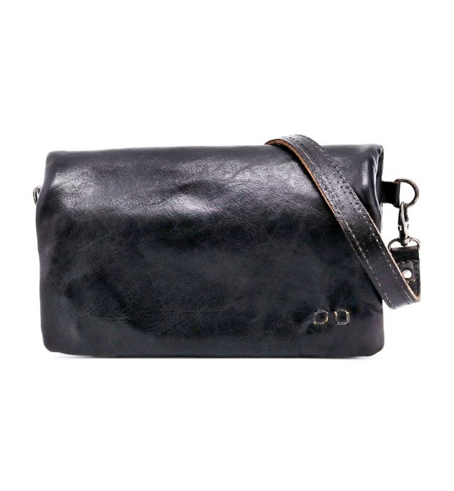 The Cadence by Bed|Stü is a black vegetable-tanned leather crossbody bag featuring a detachable strap and subtle metal detail in the bottom right corner, crafted from luxurious materials and shown against a white background.