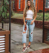 A woman wearing Fairlee II jeans by Bed Stu and sandals.