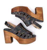 A pair of black Fontella wooden sandals with a wooden heel by Bed Stu.