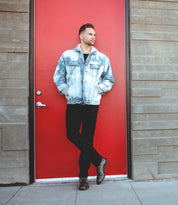 A man leaning against a Leonardo by Bed Stu red door.