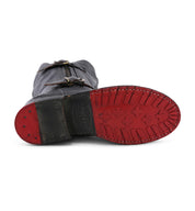 A pair of Bed Stu Gogo Lug Wide Calf boots with red soles.